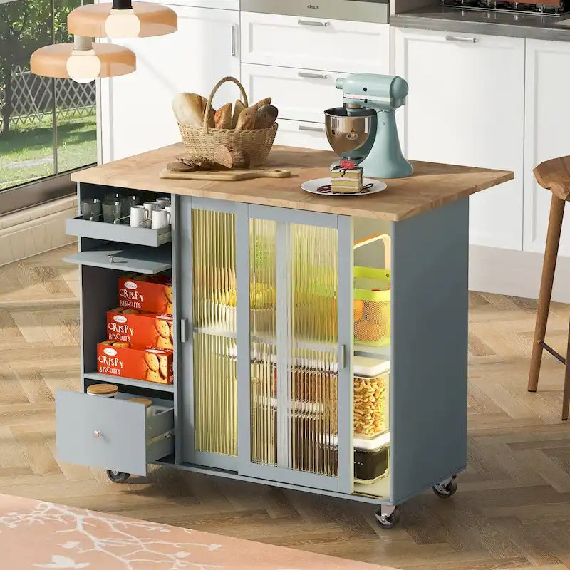 Isola da cucina con piano ribaltabile, luce LED, ante in vetro scanalato, ripiano regolabile, due cassetti e ruote