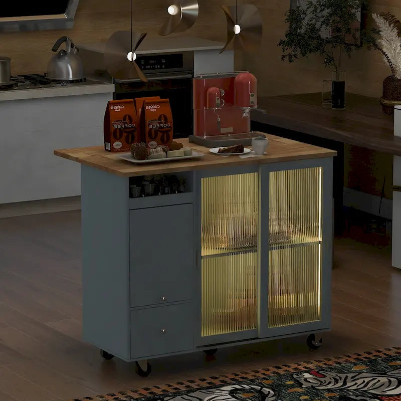 Isola da cucina con piano ribaltabile, luce LED, ante in vetro scanalato, ripiano regolabile, due cassetti e ruote
