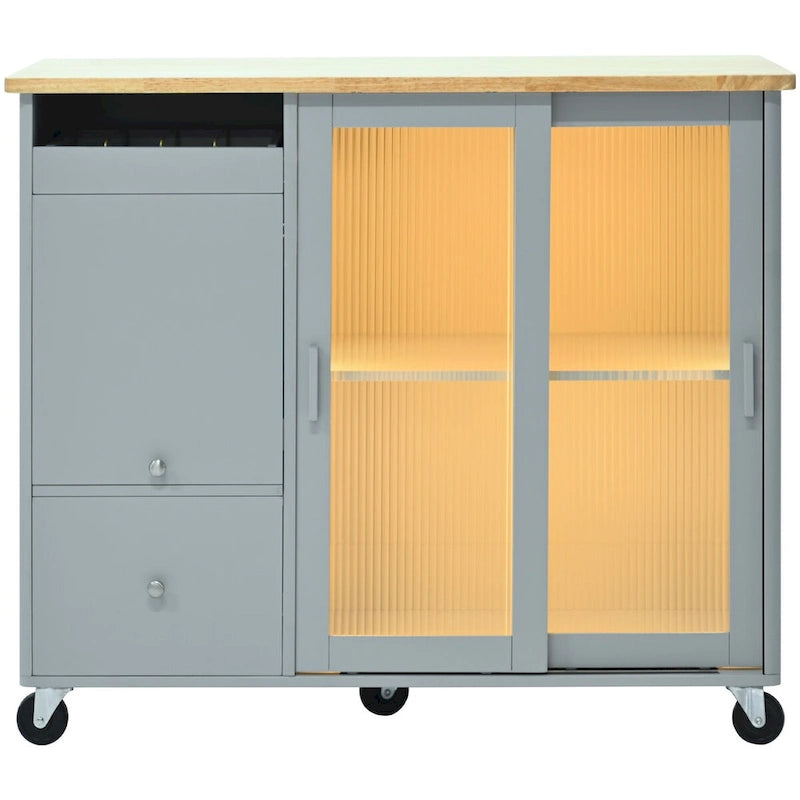 Isla de cocina con superficie abatible, luz LED, puertas de vidrio estriado, estante ajustable, dos cajones y ruedas